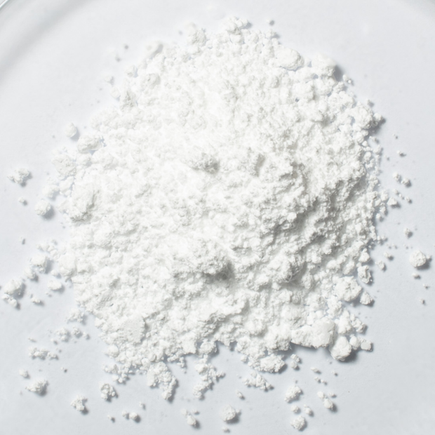 White FocusMind Pro© powder with creatine, niacin and selenium in close-up on a light background