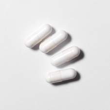 White neotes magnesium citrate capsules in close-up on a light background