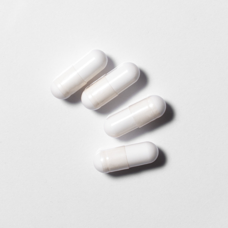 White neotes magnesium citrate capsules in close-up on a light background