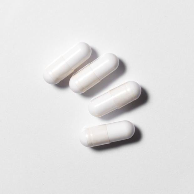 White neotes magnesium citrate capsules in close-up on a light background