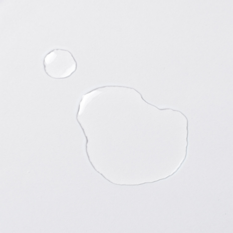 Clear selenium drop as a liquid on a white background