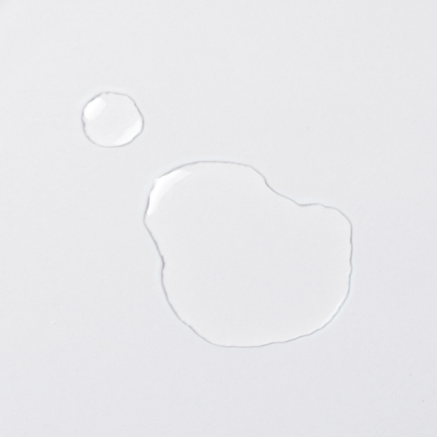 Clear selenium drop as a liquid on a white background